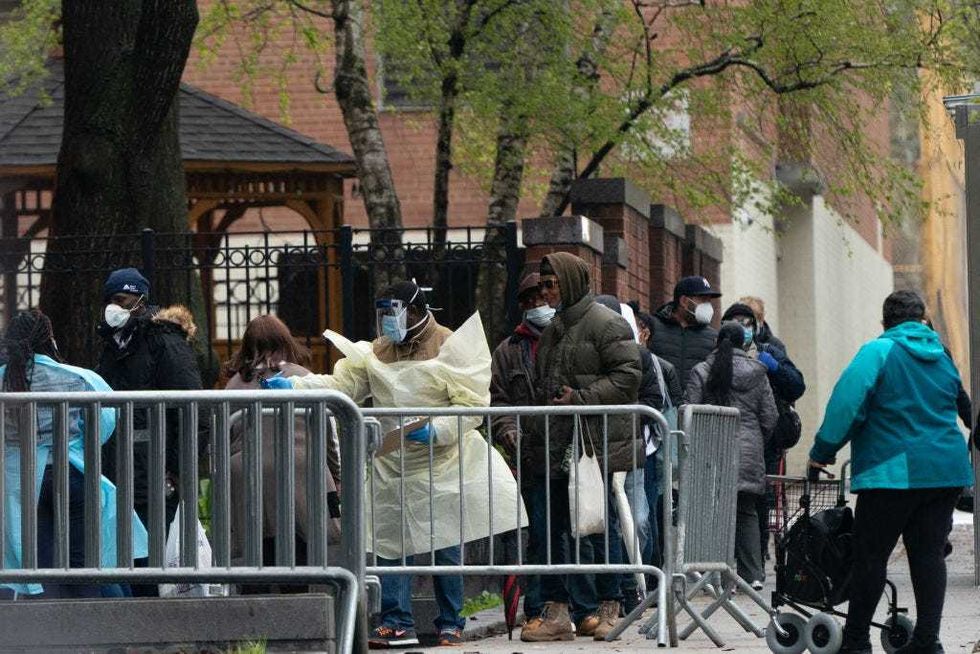 People wait in line to be tested for the coronavirus outside Gouverneur Health Center on April 24, 2020, in New York City.