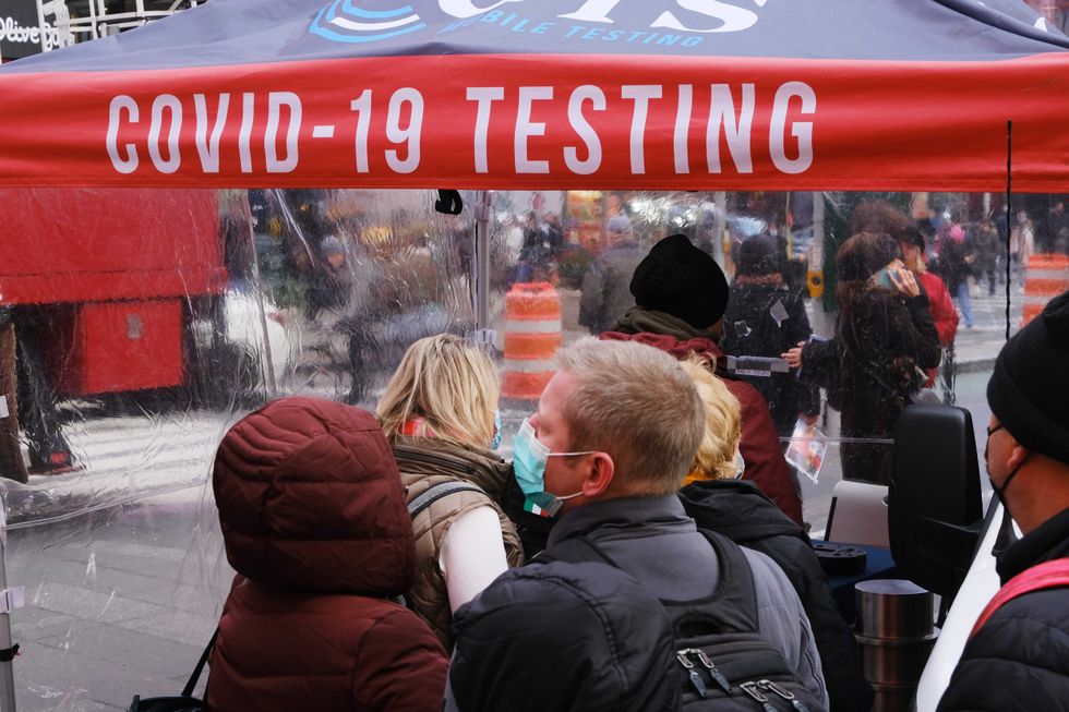 People wait in line to get tested for COVID-19 at a site in Times Square this month