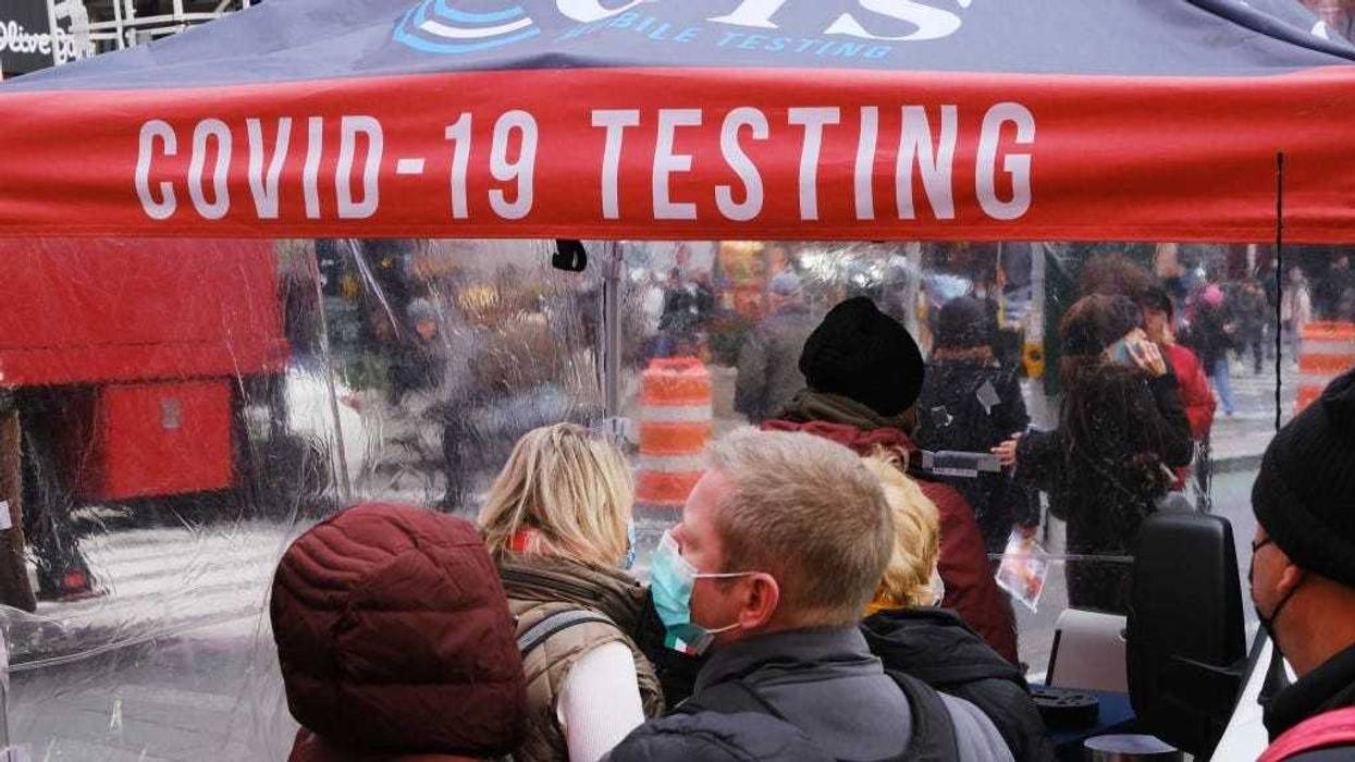People wait in line to get tested for COVID-19 at a testing facility in Times Square on December 09, 2021 in New York City. As the fast-spreading new Omicron variant of COVID-19 has been detected in at least 19 states, health officials are urging Americans to get vaccinated and receive their booster shots.
