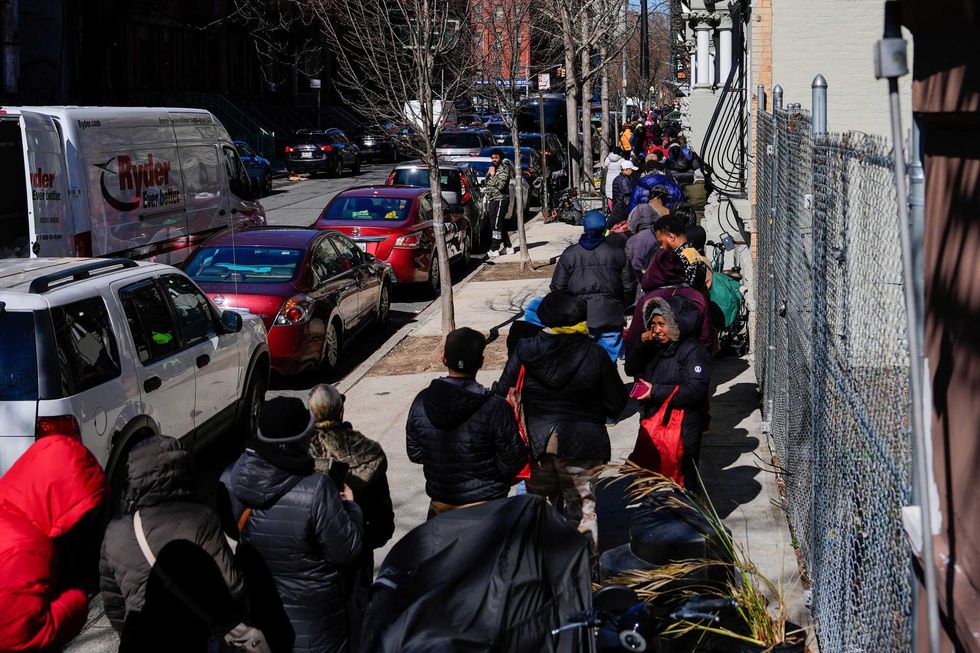 People wait in line to receive free eggs from FarmerJawn Agriculture, Friday, March 21, 2025, in the Harlem neighborhood of New York.