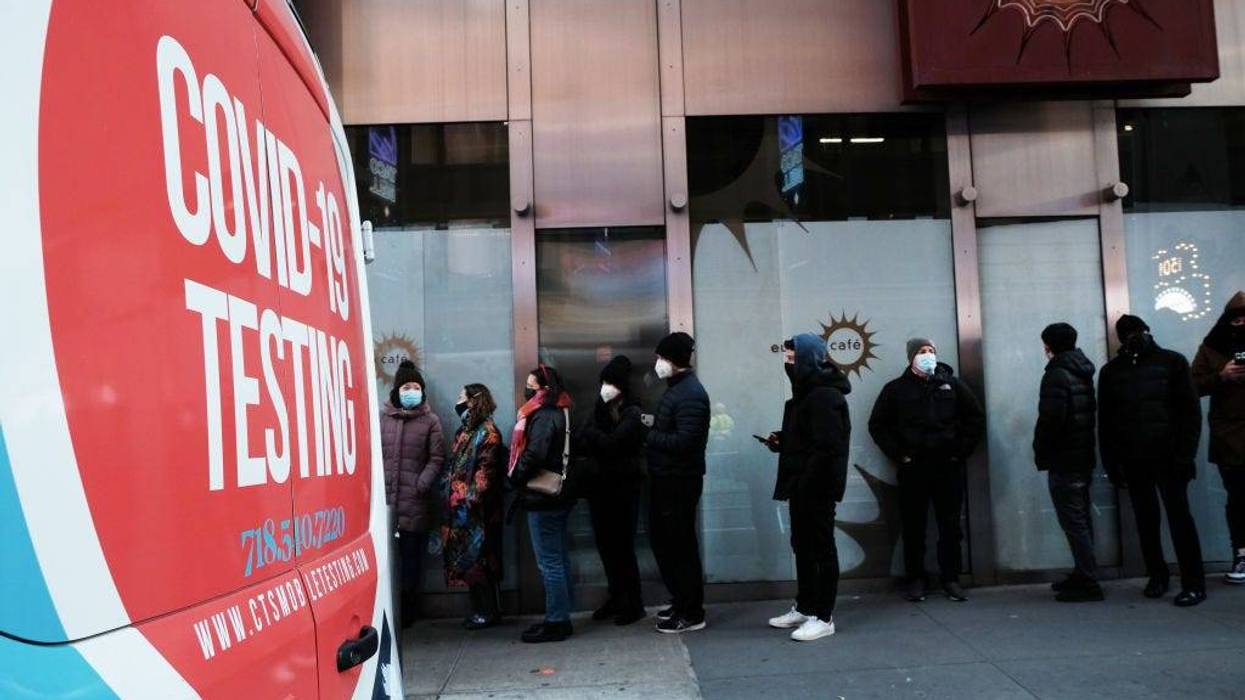 People wait in long lines in Times Square to get tested for COVID-19 on Dec. 20, 2021, in New York City.