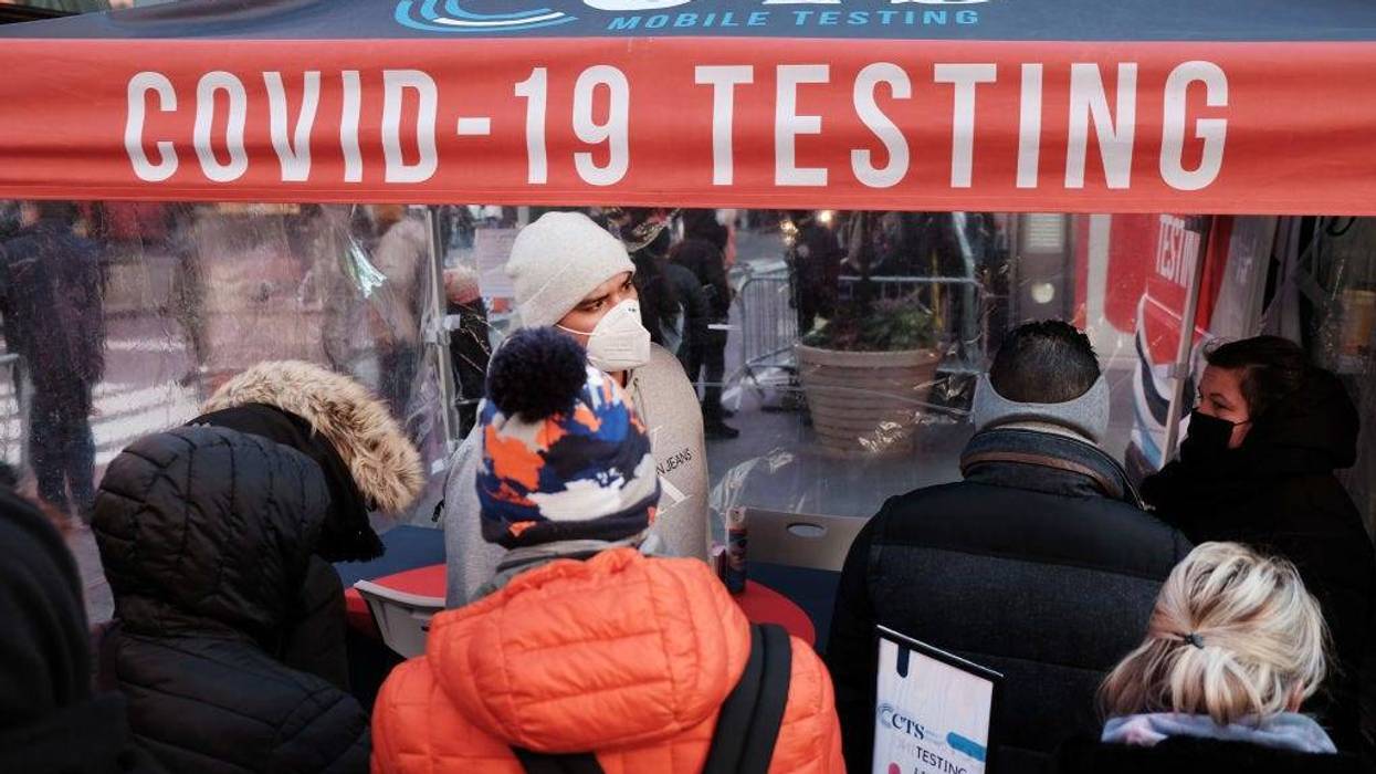 People wait in long lines in Times Square to get tested for Covid-19 on December 20, 2021 in New York City.
