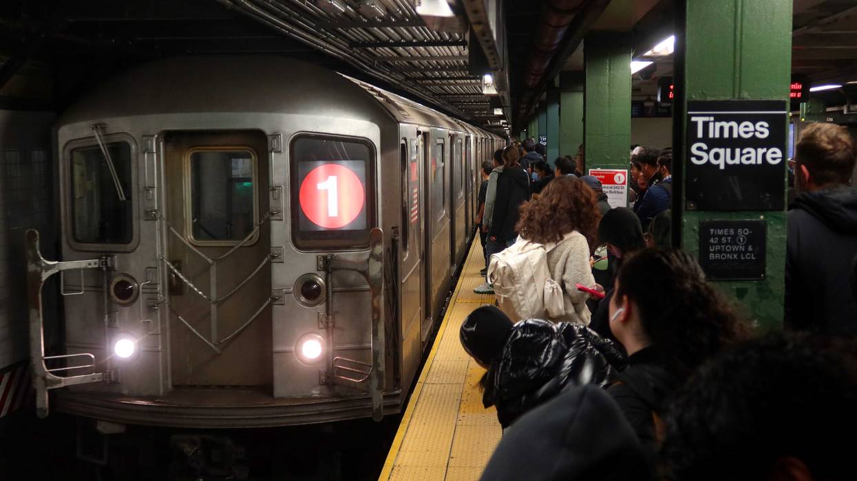 People wait to board a 1-line train at the Times Square station on November 12, 2024
