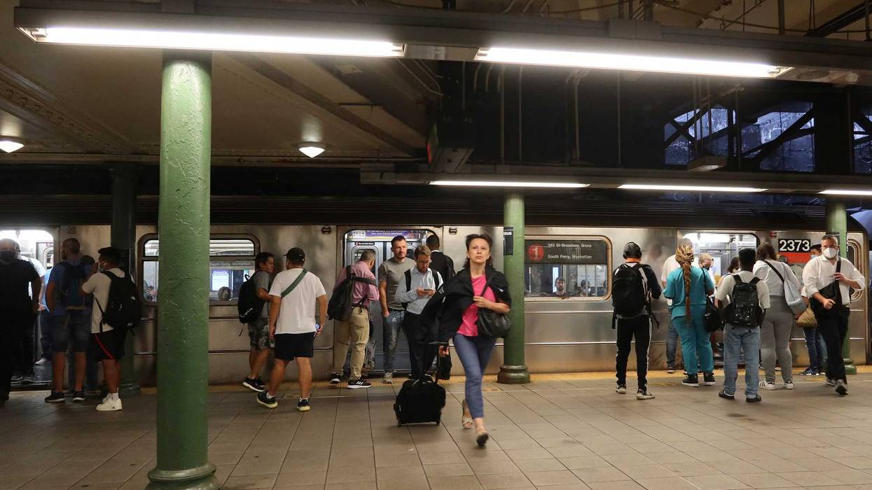 People wait to board a 1 subway train at the Columbus Circle - 59th Street station.