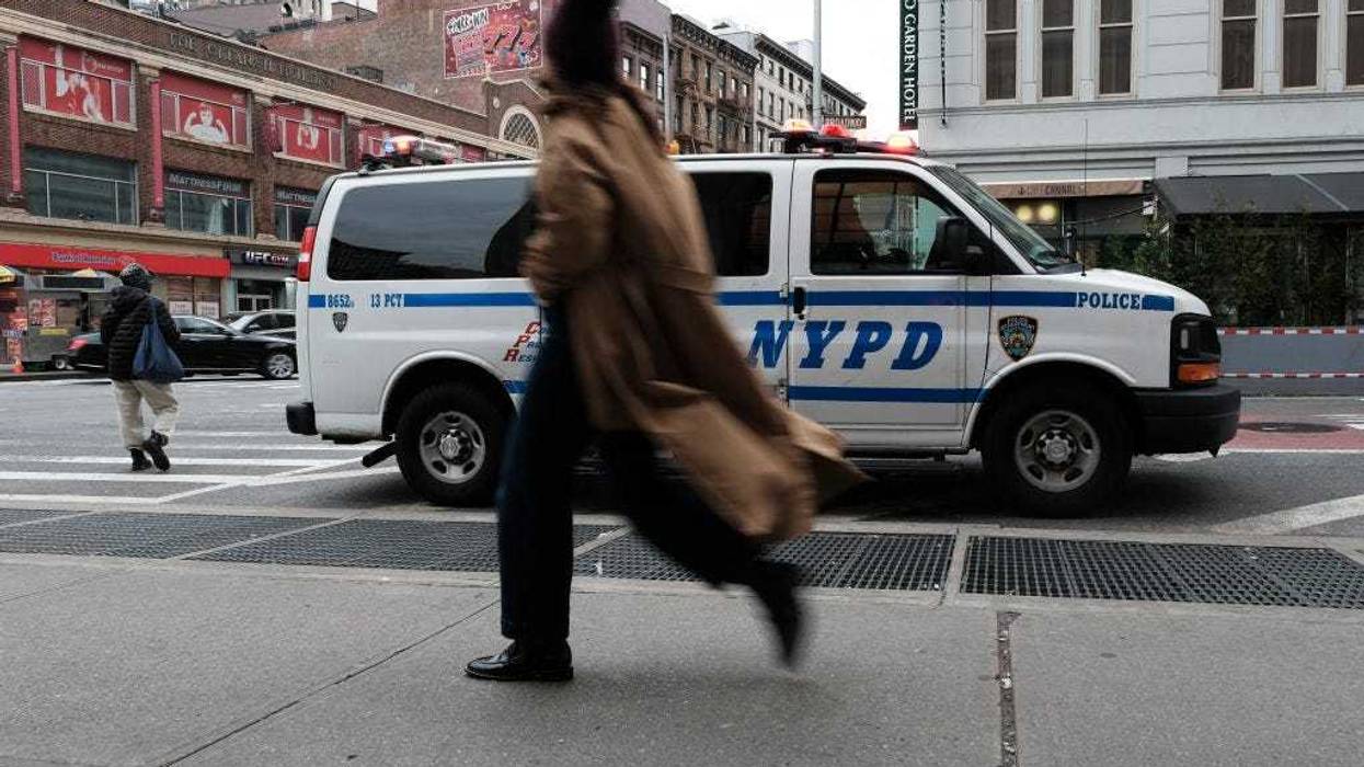 People walk along Canal Street in Manhattan a day after a major police seizure of counterfeit goods in the area on November 29, 2022 in New York City.