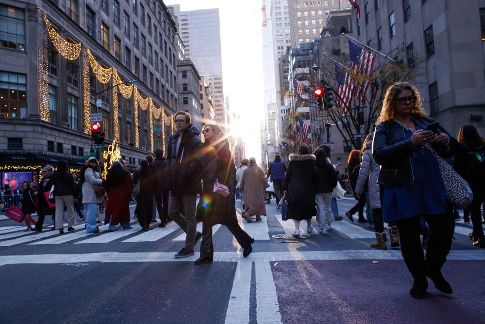 People walk along Fifth Avenue during the 200th years anniversary celebration on Dec. 8, 2024