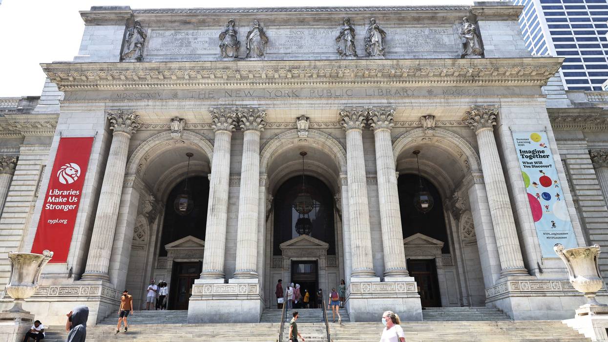People walk along the stairs of the New York Public Library on July 6, 2021 in midtown Manhattan