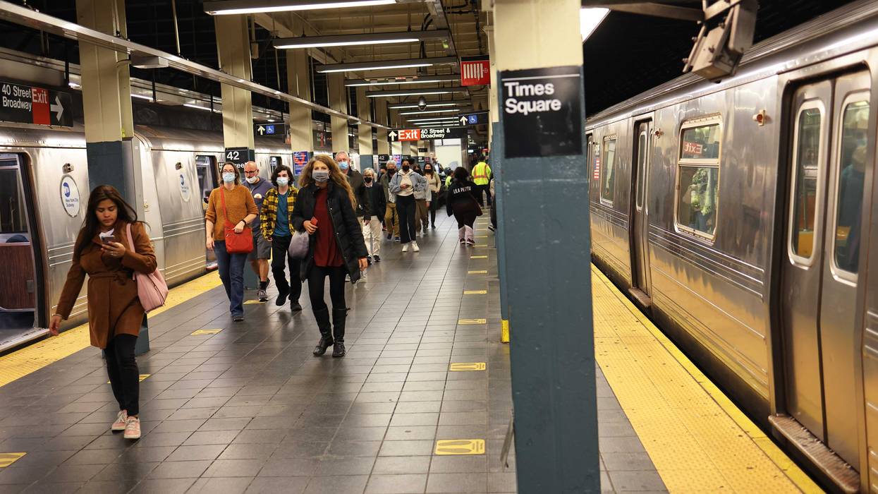 People walk along the train platform at the 42nd Street subway station on Nov. 09, 2021
