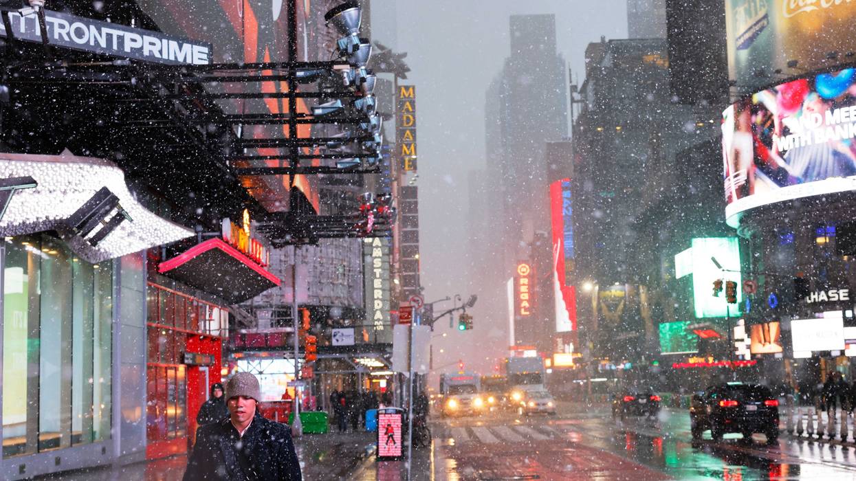 People walk along Times Square during a winter storm
