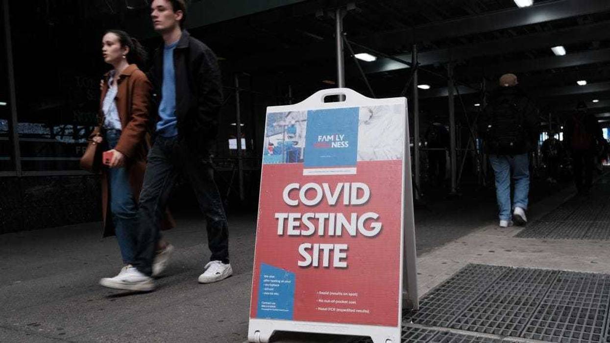 People walk by a COVID-19 testing site in downtown Manhattan on March 31, 2022 in New York City.