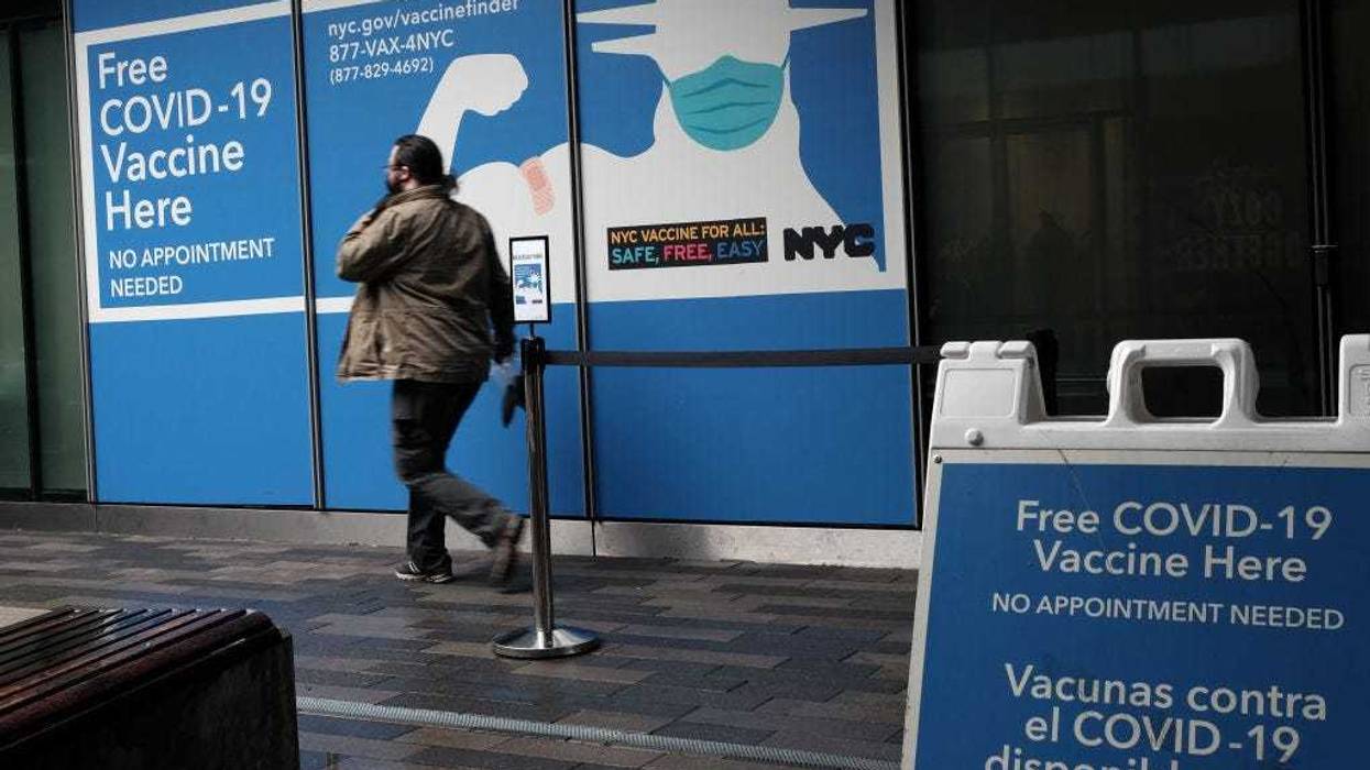 People walk by a Covid-19 vaccination site at a mall near the Staten Island Ferry Terminal on January 05, 2022 in New York City.