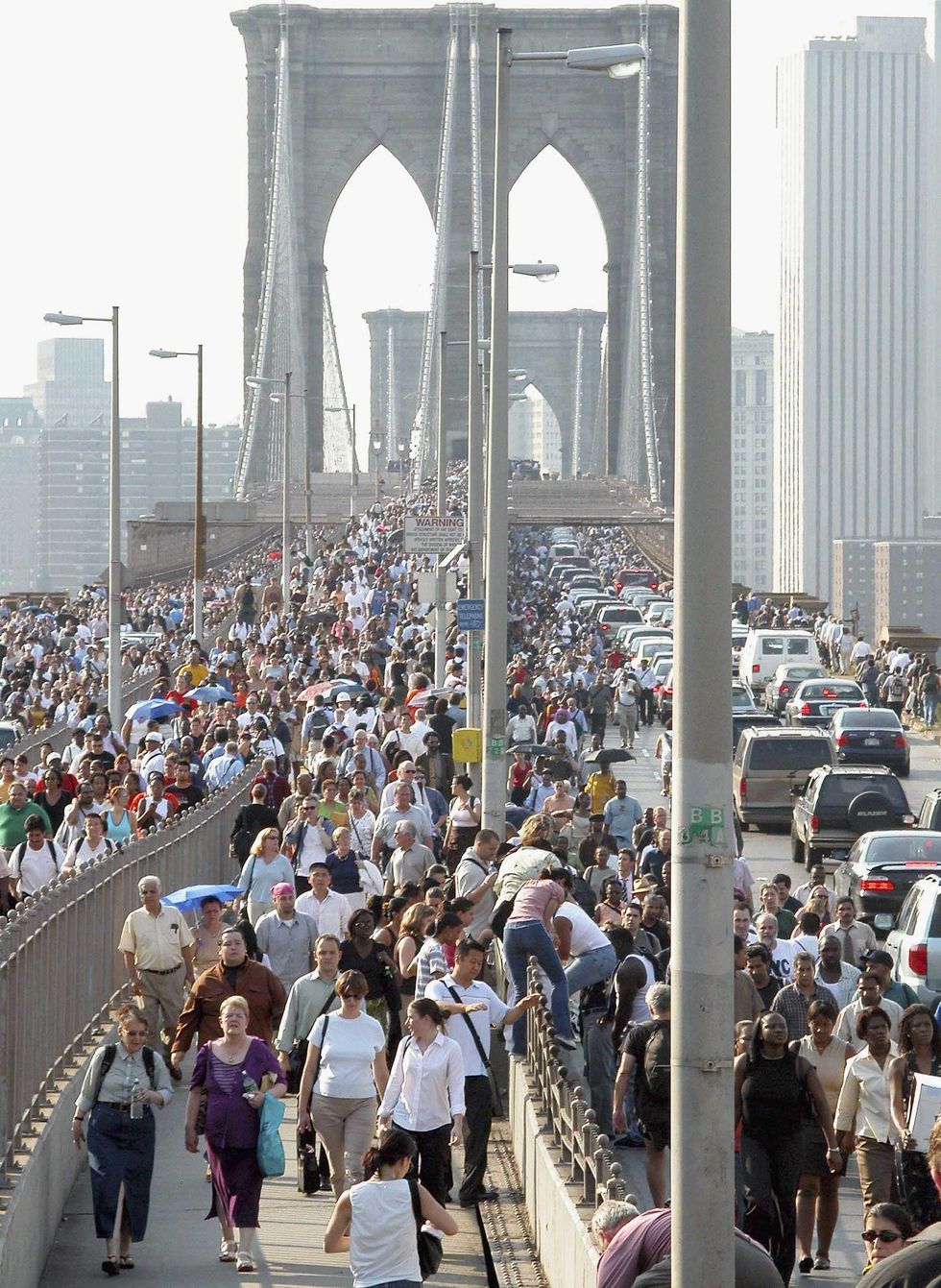 People walk down Brooklyn Bridge during a massive blackout Aug. 14, 2003 in New York City.
