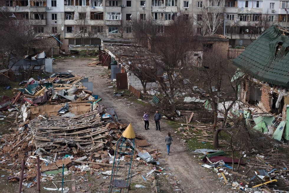 People walk in a destroyed residential area on April 7, 2022 in Borodianka, Ukraine