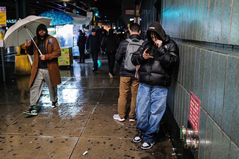 People walk in Queens on the night of Jan. 9, 2024