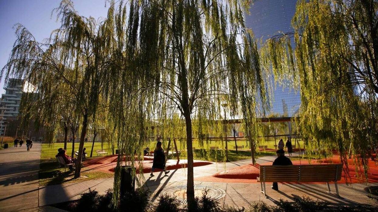 people walk in Tree Library park in Milan, Italy.