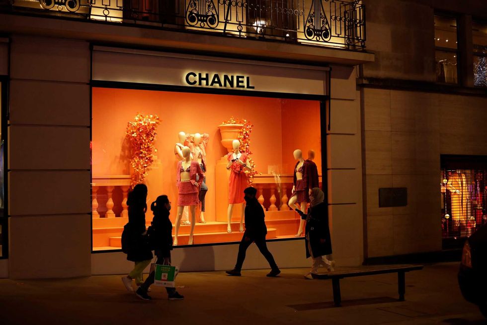 People walk past a Chanel shop on New Bond Street in London on Nov. 25, 2020