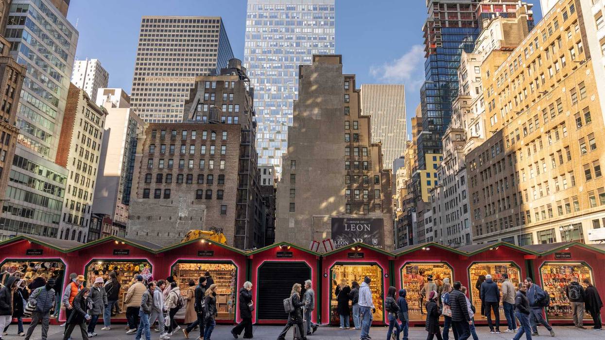 People walk past a Christmas market on 5th Avenue on Nov. 29, 2024 in New York City. Black Friday sales will give economists a glimpse into consumers' holiday shopping mood.