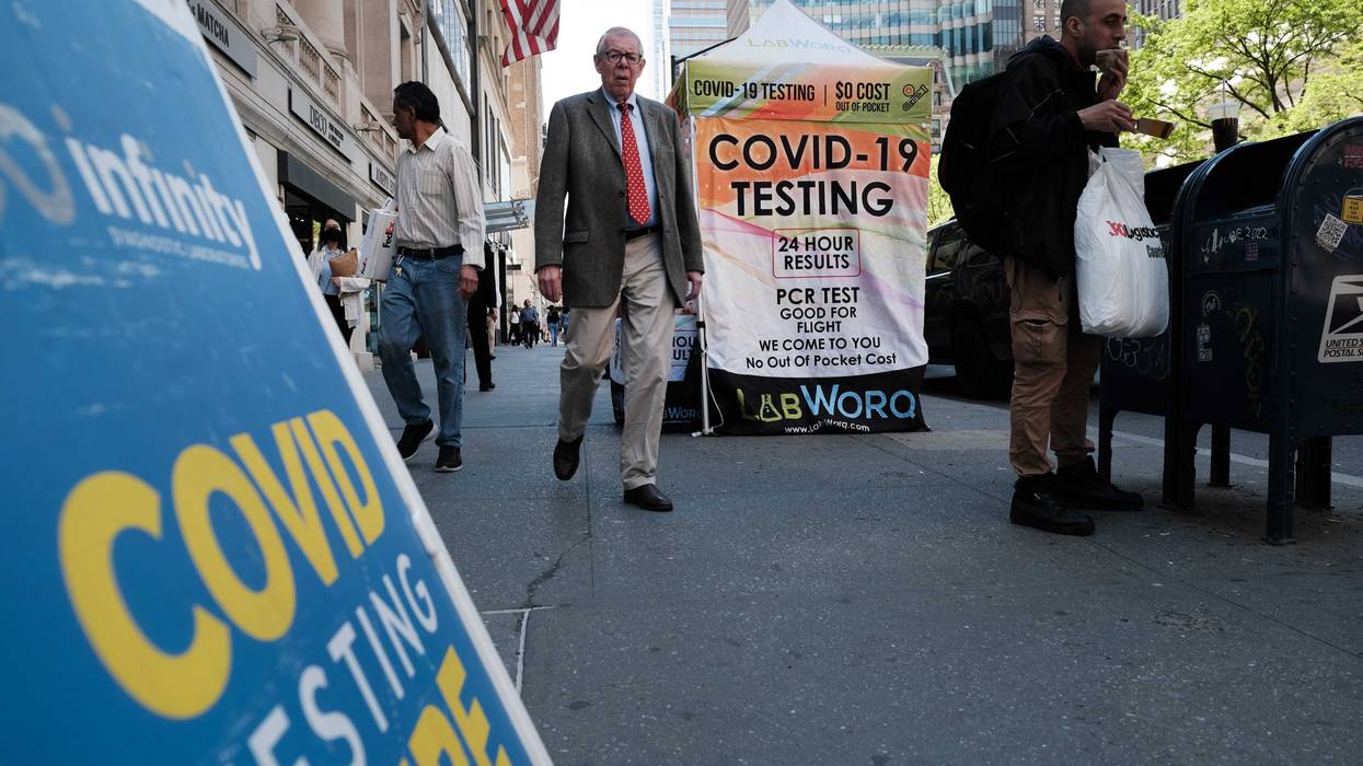 People walk past a COVID testing site on May 17, 2022 in New York City. New York’s health commissioner, Dr. Ashwin Vasan, has moved from a "medium" COVID-19 alert level to a "high" alert level in all the five boroughs following a surge in cases.
