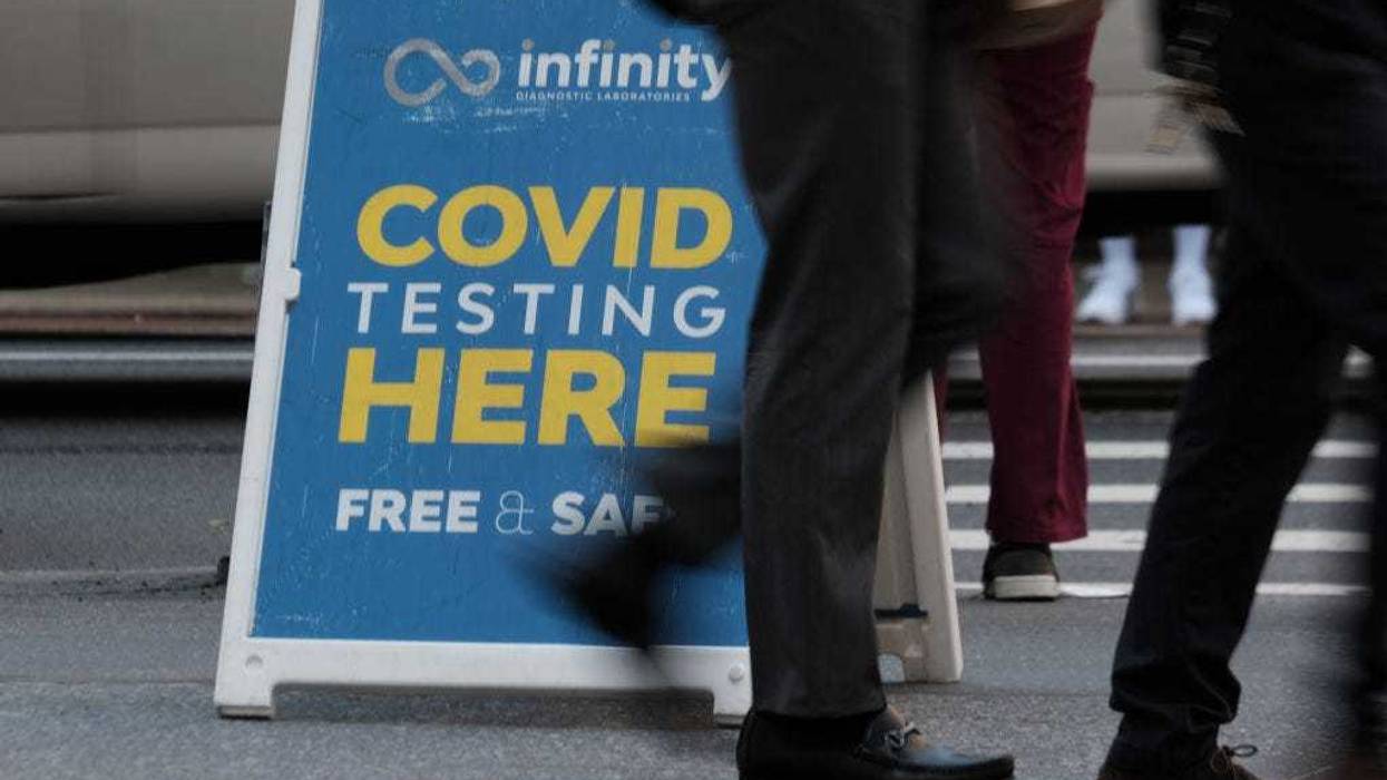 People walk past a Covid testing site on May 17, 2022 in New York City. New York’s health commissioner, Dr. Ashwin Vasan, has moved from a "medium" COVID-19 alert level to a "high" alert level in all the five boroughs following a surge in cases. (Photo by Spencer Platt/Getty Images)