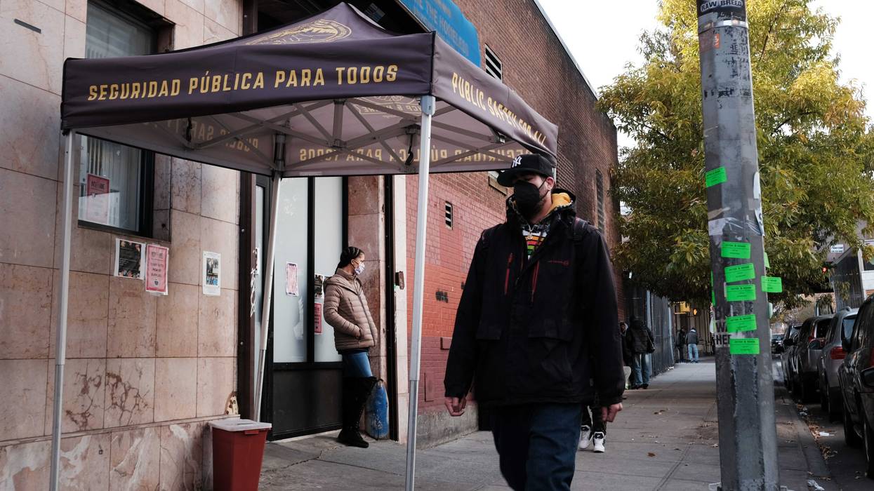People walk past an East Harlem health clinic that offers free needles and other services to drug users on Dec. 1, 2021