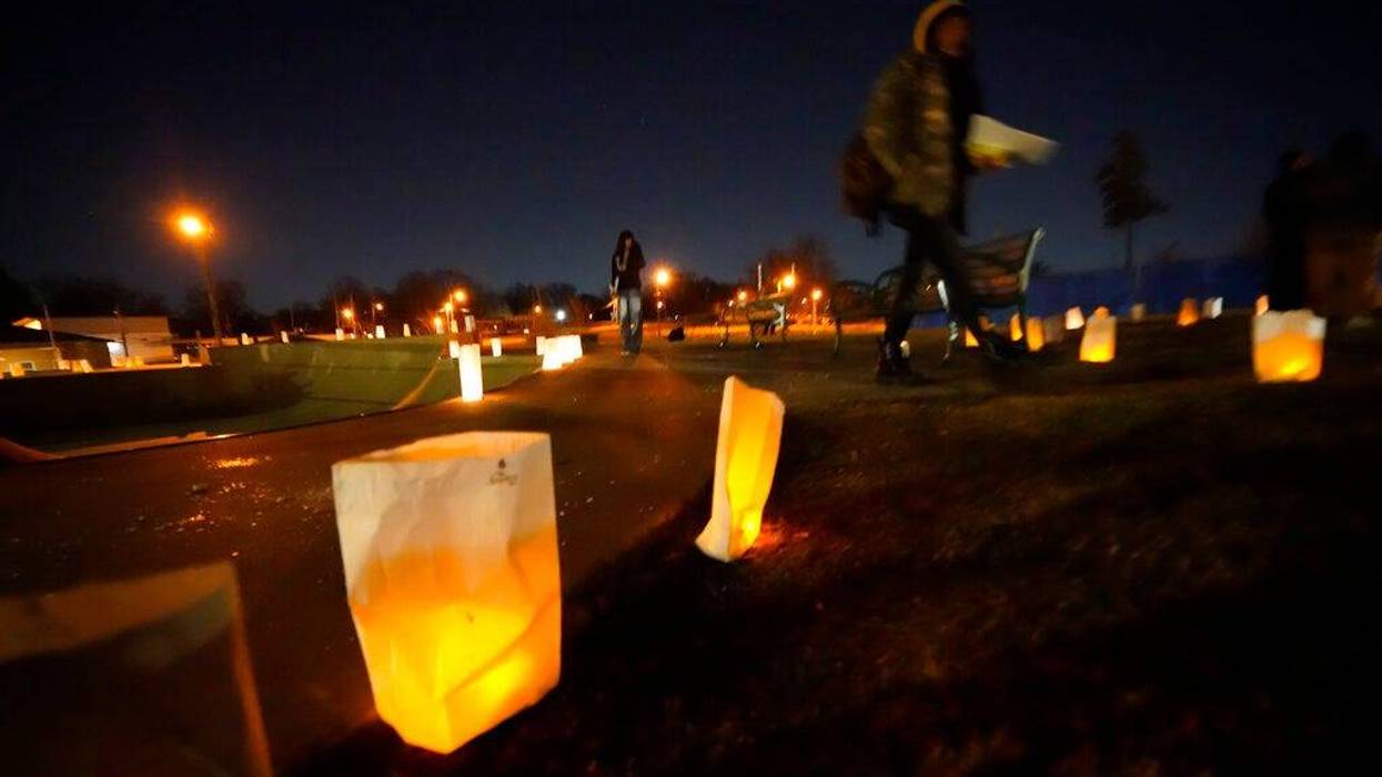 People walk past candles after vigil for Tyre Nichols
