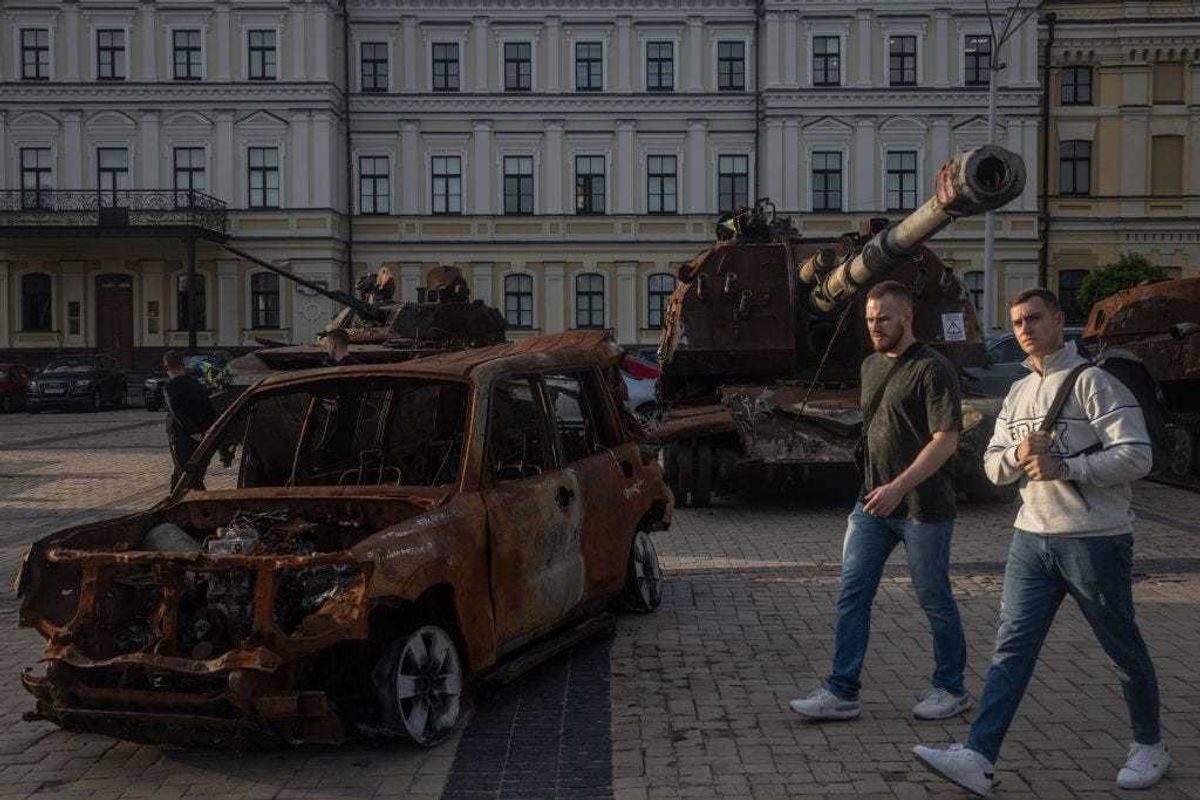 People walk past destroyed tanks and military vehicles displayed in a square in front of St. Michael's Golden-Domed Monastery on September 21, 2023 in Kyiv, Ukraine. (Photo by Chris McGrath/Getty Images)