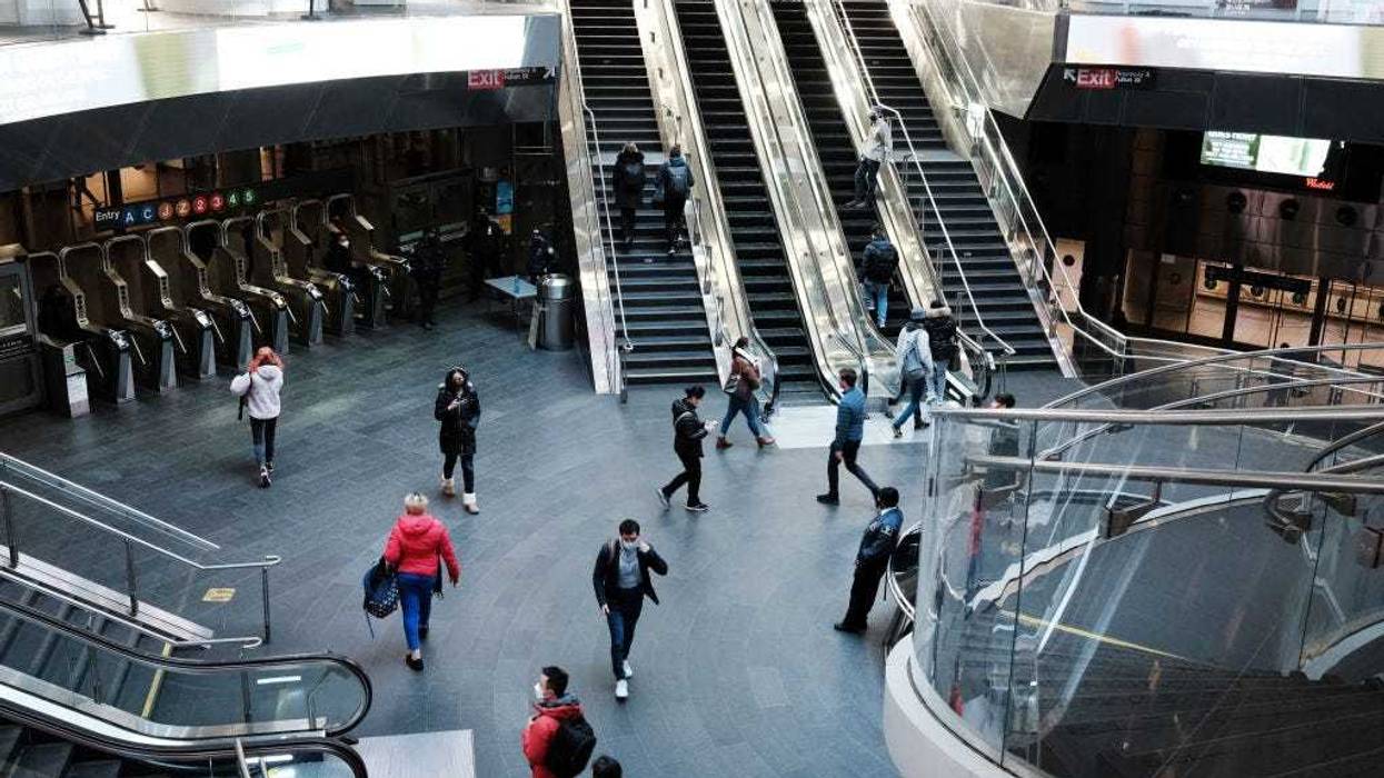 People walk through the Fulton Street subway station in lower Manhattan on March 11, 2022 in New York City.