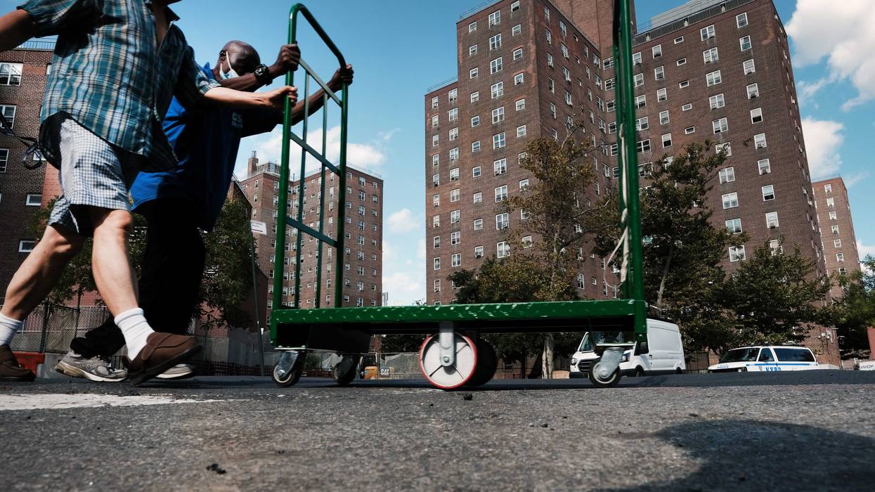 People walk through the Jacob Riis Houses as residents and activists gather for a protest against the living conditions at the public housing complex in the East Village on Sept. 14, 2022