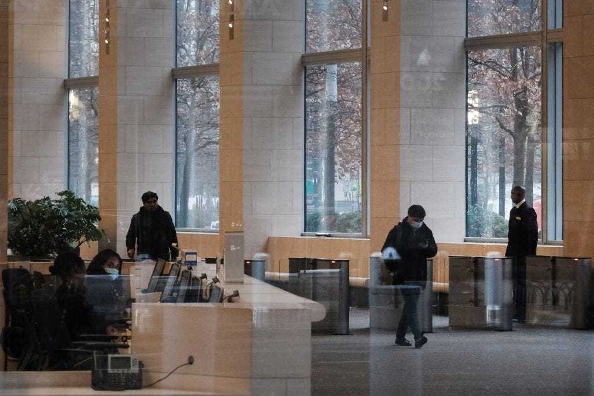 People walk through the lobby of the Goldman Sachs headquarters in Manhattan on December 16, 2022 in New York City. Goldman Sachs, the global investment bank, has announced that it plans on cutting up to 8% of its employees early next year as world economies and markets continue to struggle with inflation, the war in Ukraine and China's Covid policies among other issues. (Photo by Spencer Platt/Getty Images)
