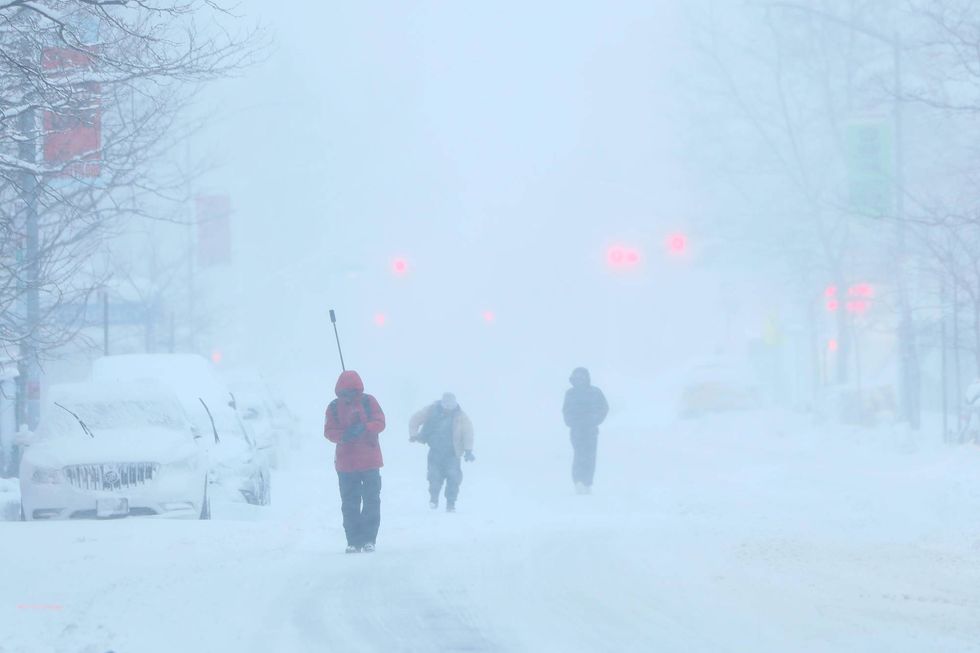 People walk through the snow in Flatbush, Brooklyn, on Monday morning