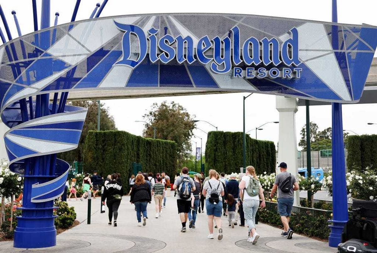 People walk toward an entrance to Disneyland on April 24, 2023 in Anaheim, California.