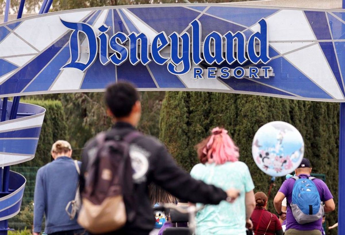 People walk toward an entrance to Disneyland on April 24, 2023 in Anaheim, California.