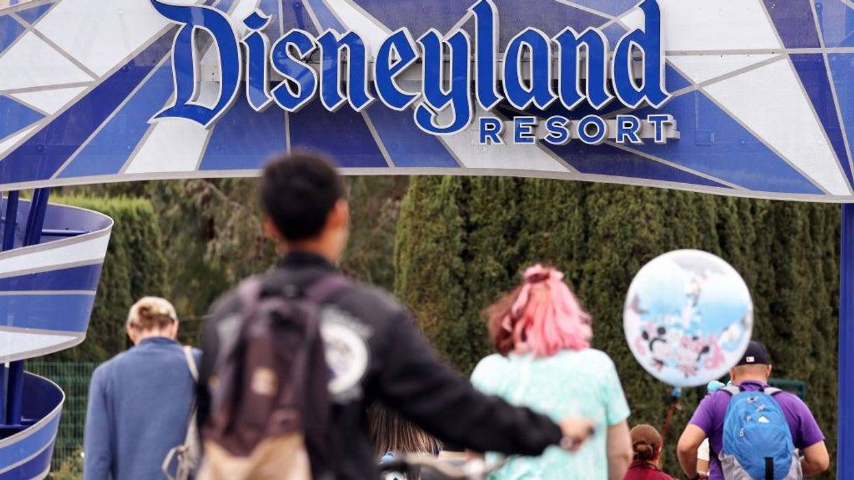 People walk toward an entrance to Disneyland on April 24, 2023 in Anaheim, California.