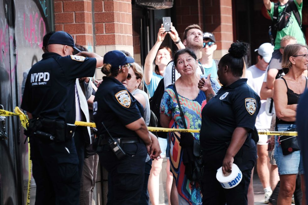 People watch as the FDNY responds to the collapse