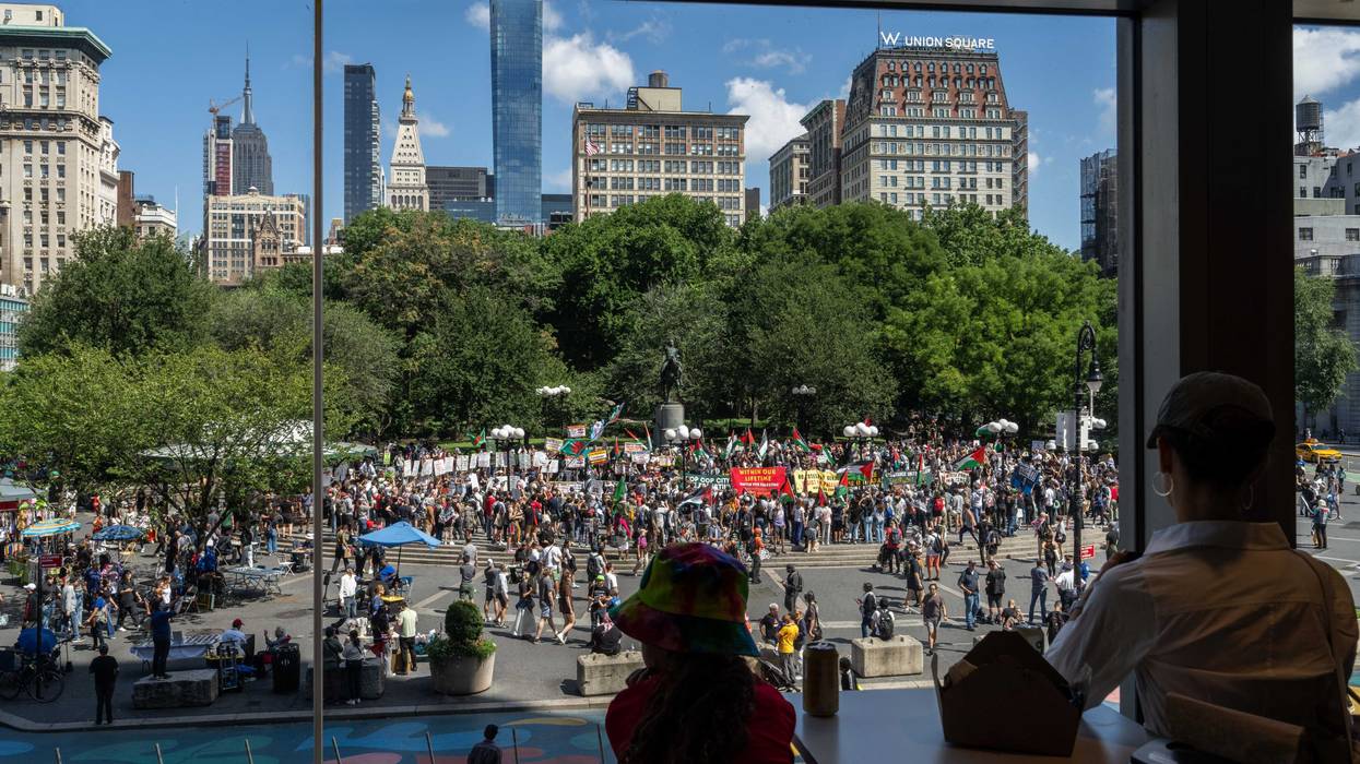 People watch from a window as people attend a protest on Labor Day in Union Square on Sept. 2, 2024 in New York City. Following the deaths of six hostages in Gaza, protestors demand that Israel reach a deal with Hamas.