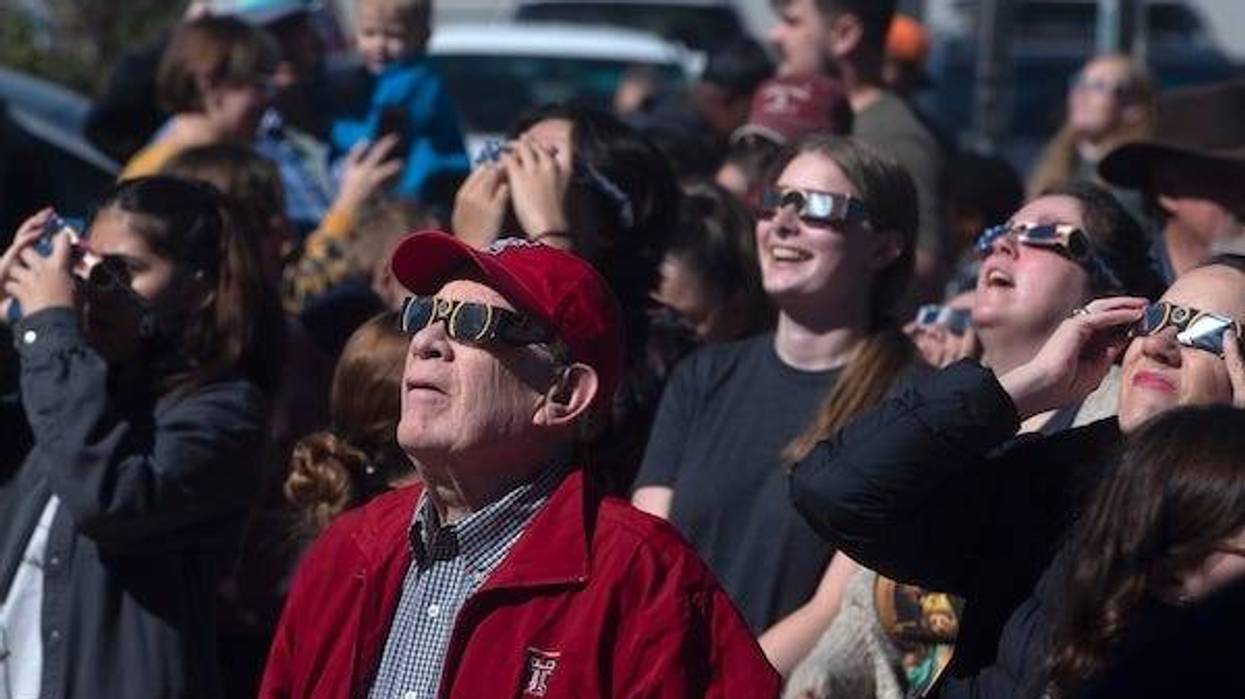People watch the solar eclipse, Saturday, Oct. 14, 2023, at the Science Spectrum