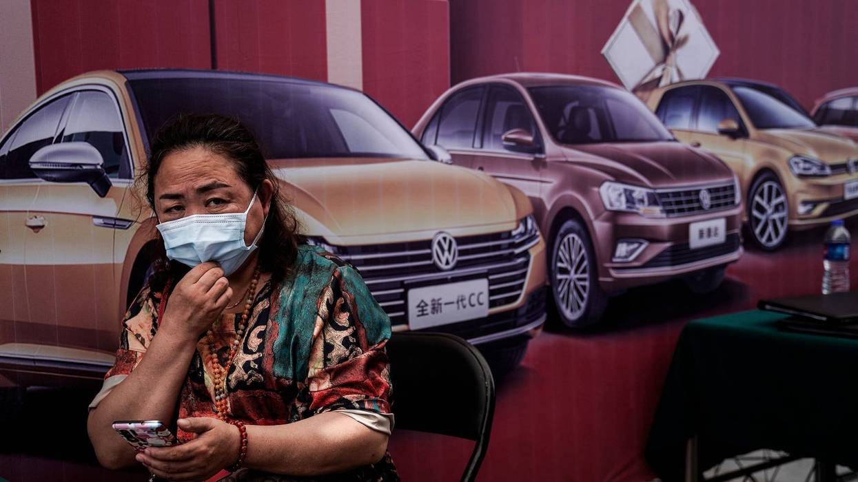 People wear face masks while visits the Auto Fair during Dragon Boat Festival holiday on June 25, 2020 in Wuhan, China.