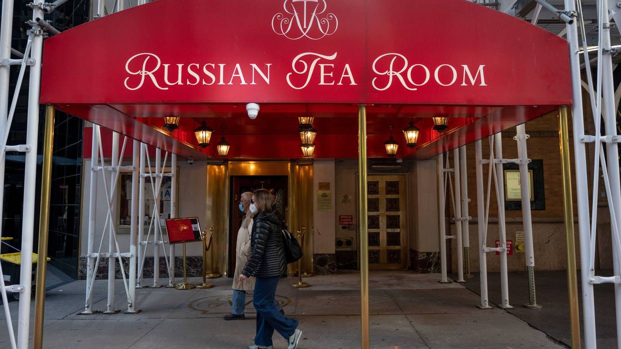 People wearing masks walk past the recently reopened Russian Tea Room on October 17, 2020 in New York City.