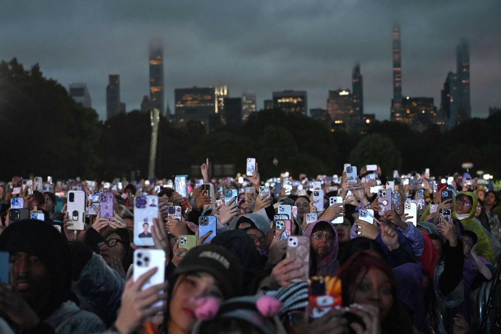 People wearing raincoats attend Global Citizen Festival at Central Park in New York City on September 23, 2023