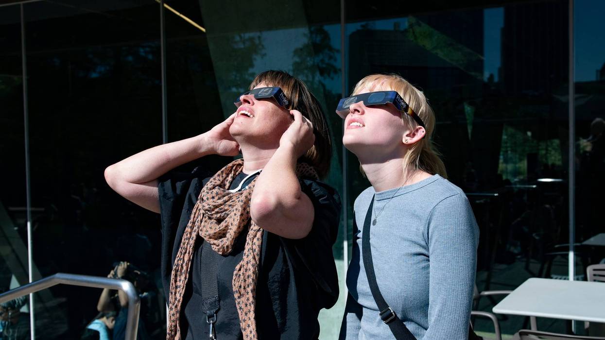 People where eclipse glasses at the Perot Museum of Nature and Science in Dallas, Texas.