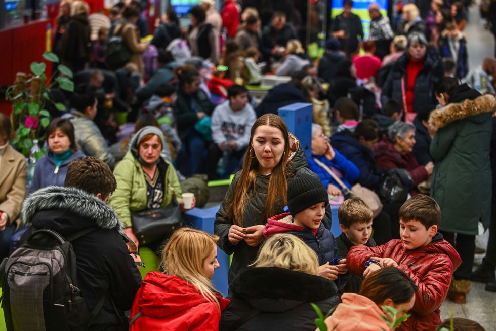 People who fled the war in Ukraine rest as they wait for shelter relocation or to take a train to another European destination at the train station on March 15, 2022 in Krakow, Poland