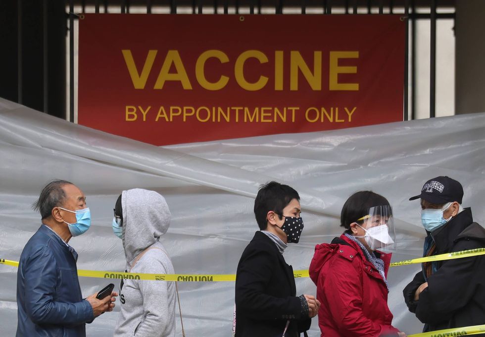 People with appointments stand in line to receive the COVID-19 vaccine at a vaccination site at Lincoln Park in East Los Angeles amid eased lockdown restrictions on January 28, 2021 in Los Angeles, California.