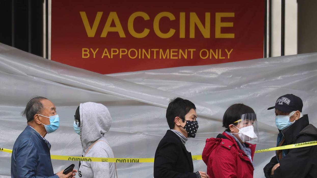People with appointments stand in line to receive the COVID-19 vaccine at a vaccination site at Lincoln Park in East Los Angeles amid eased lockdown restrictions on January 28, 2021 in Los Angeles, California.