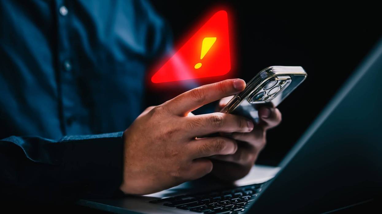 People with warning notification and spam message icon on mobile phone