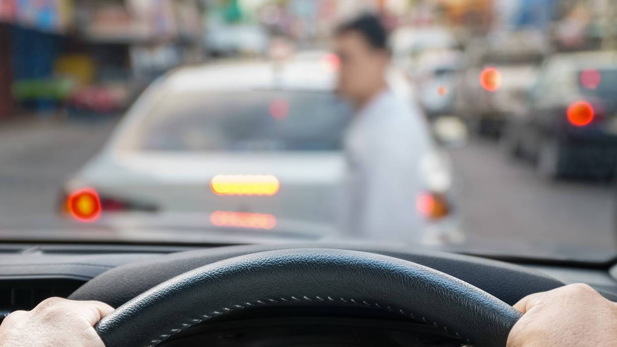 person driving car, blurry pedestrian