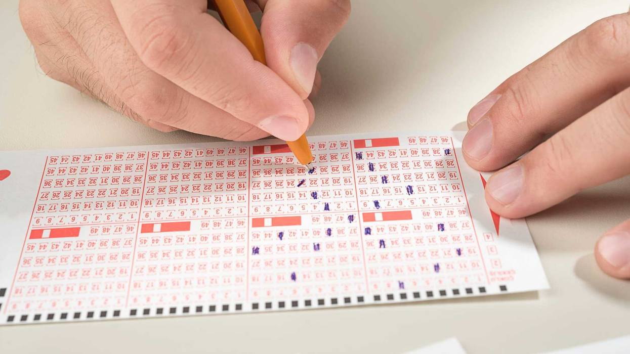 Person filling out a lottery ticket.