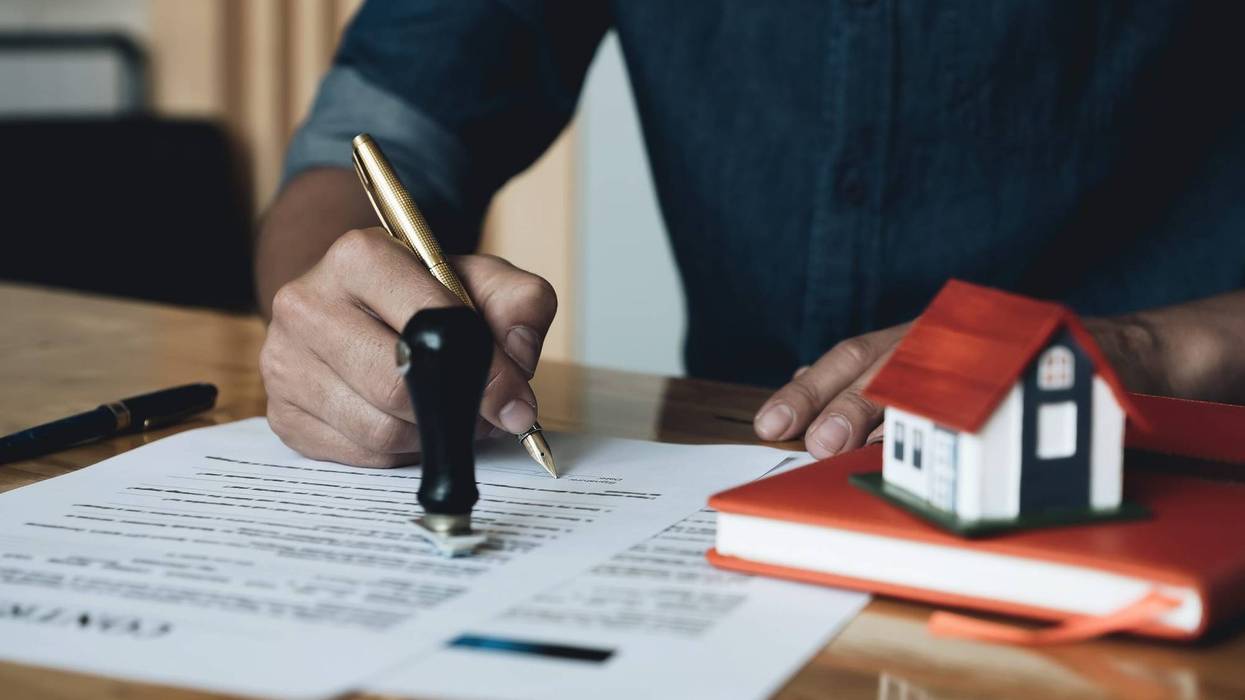 Person filling out property insurance.