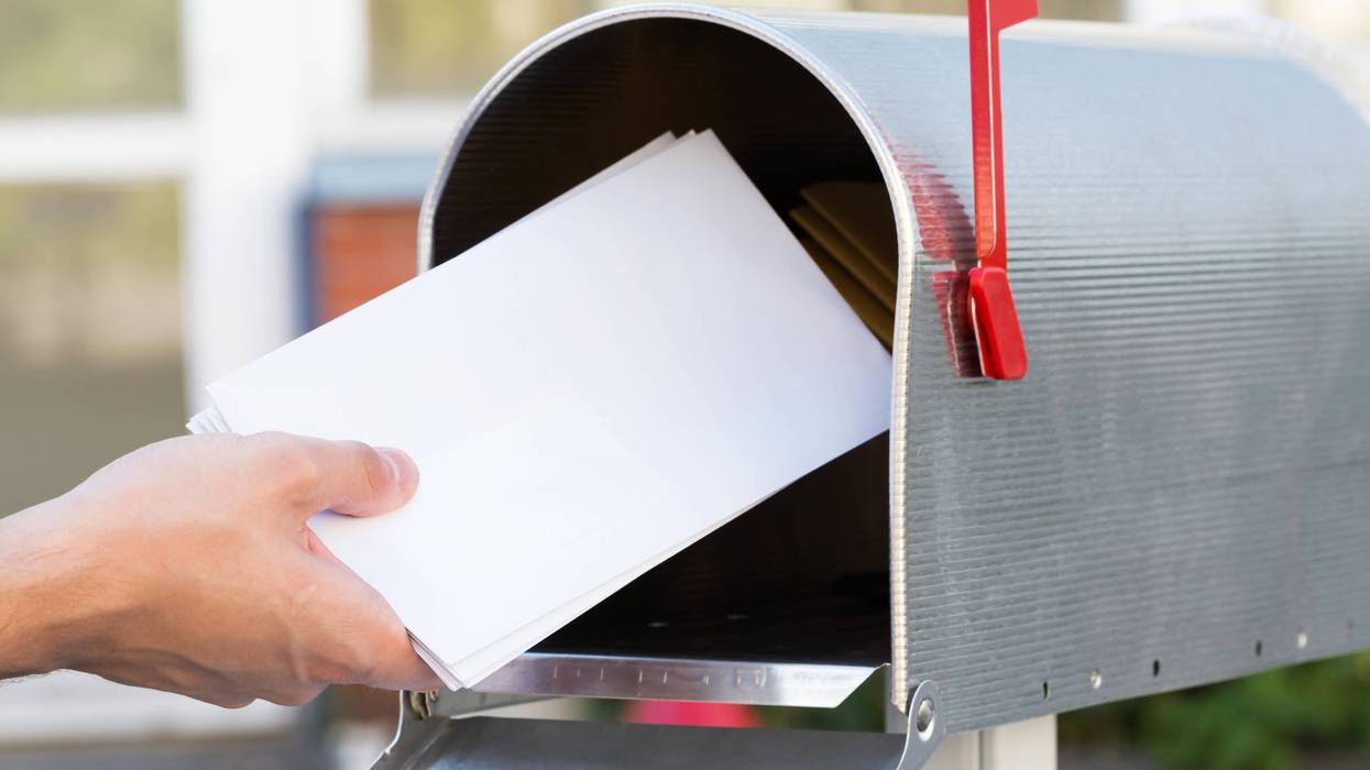 person grabbing mail