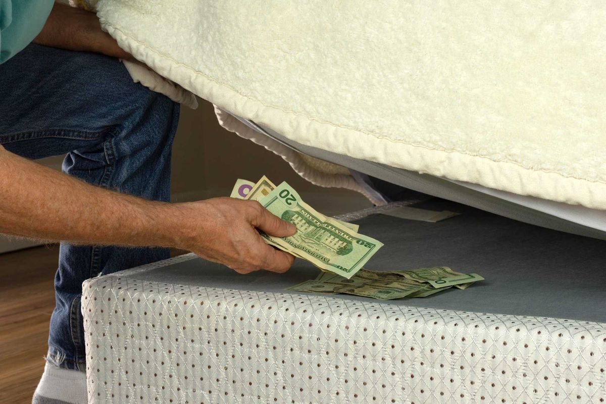 Person hiding money under his mattress.