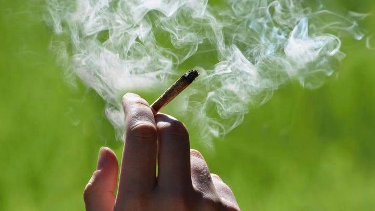 Person holding smoking joint